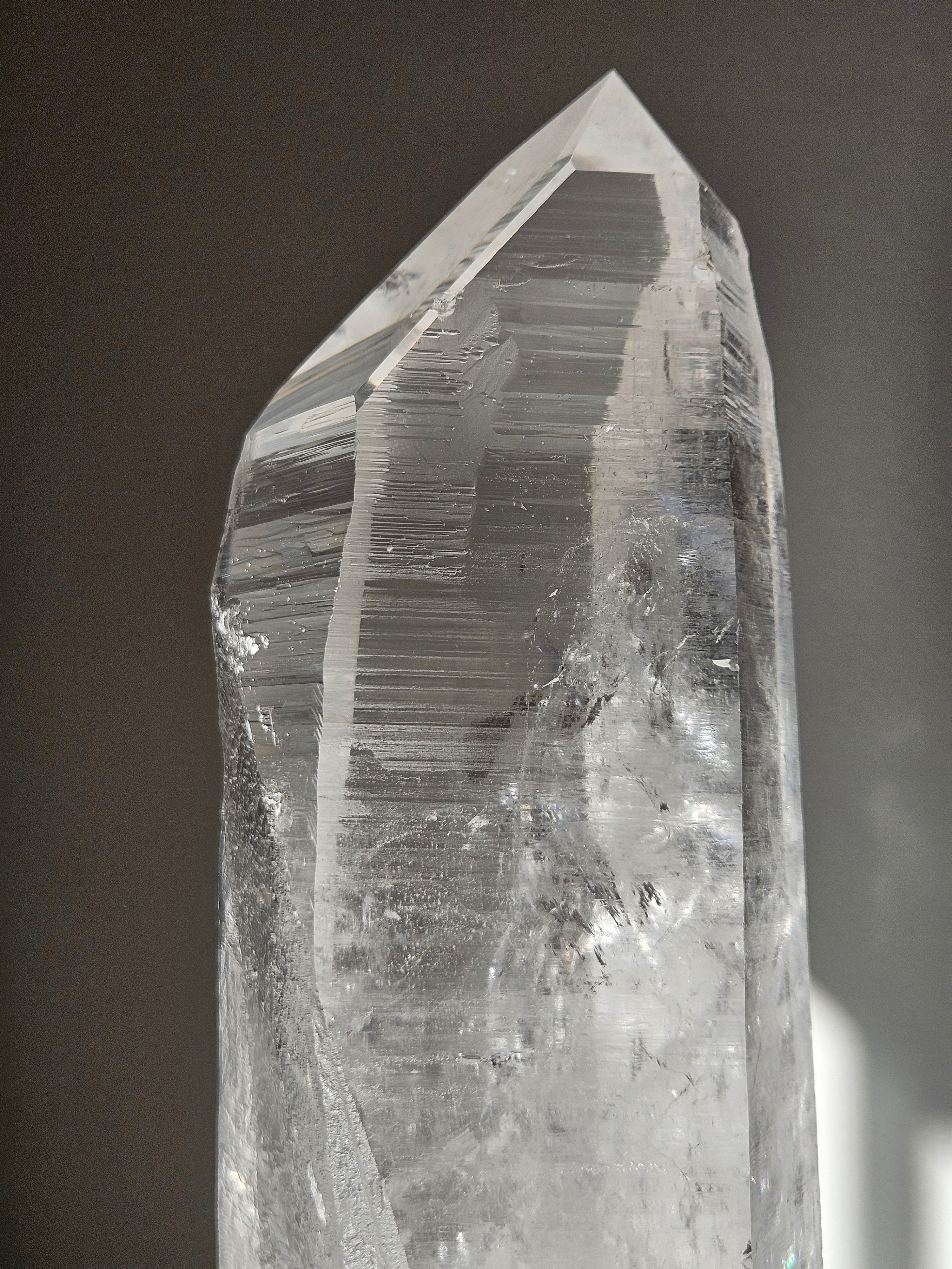 Semipolished Lemurian Point on Spinning Stand