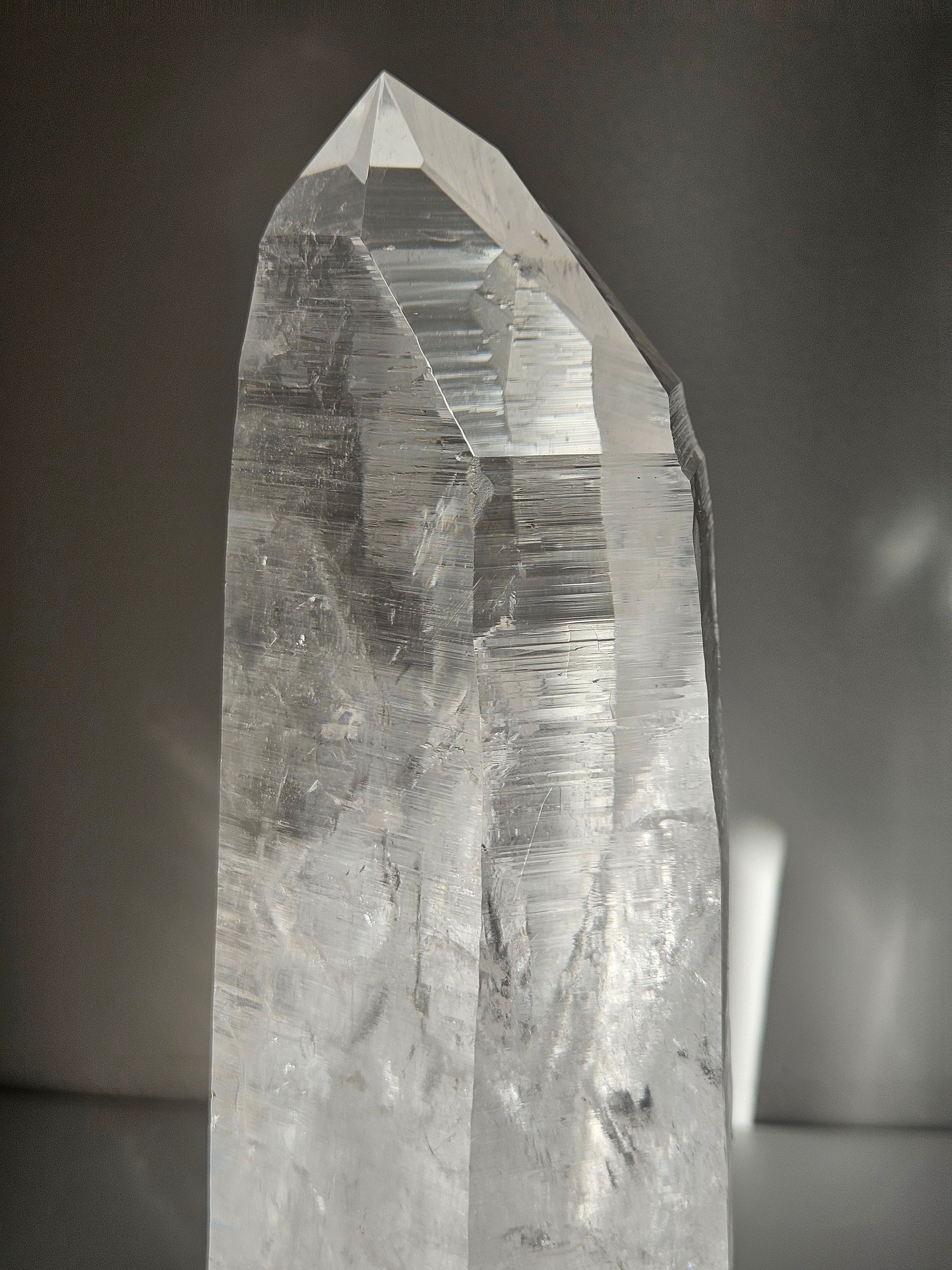Semipolished Lemurian Point on Spinning Stand