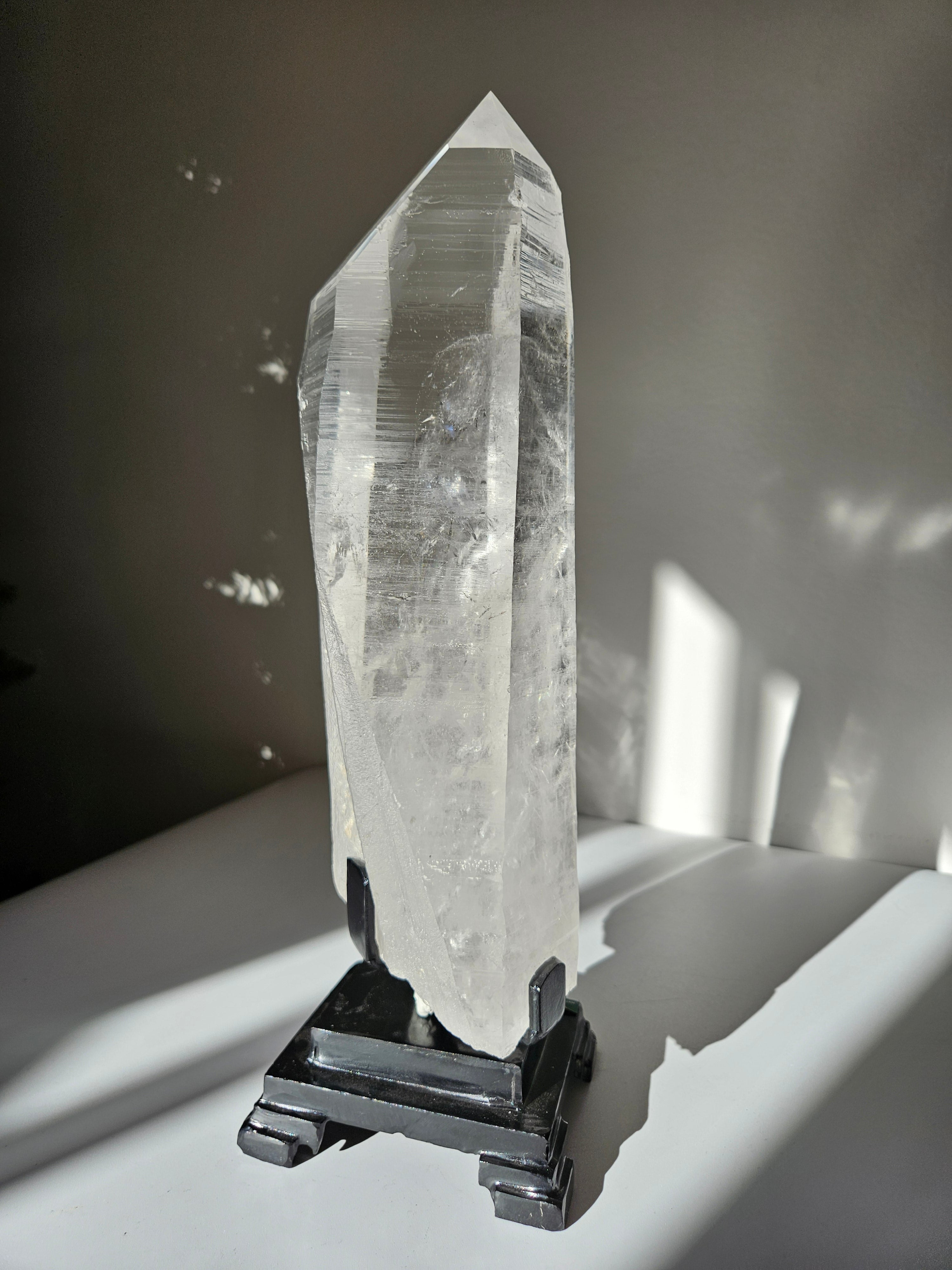 Semipolished Lemurian Point on Spinning Stand
